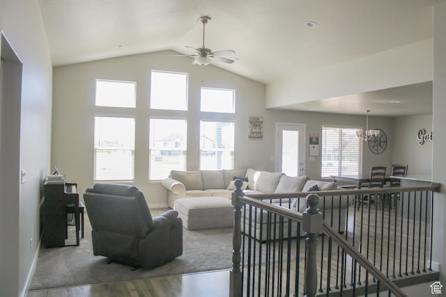 2447 N 2950 W, Plain City, UT 84404 - living room featuring wood finished floors, ceiling fan, a chandelier, baseboards, and lofted ceiling