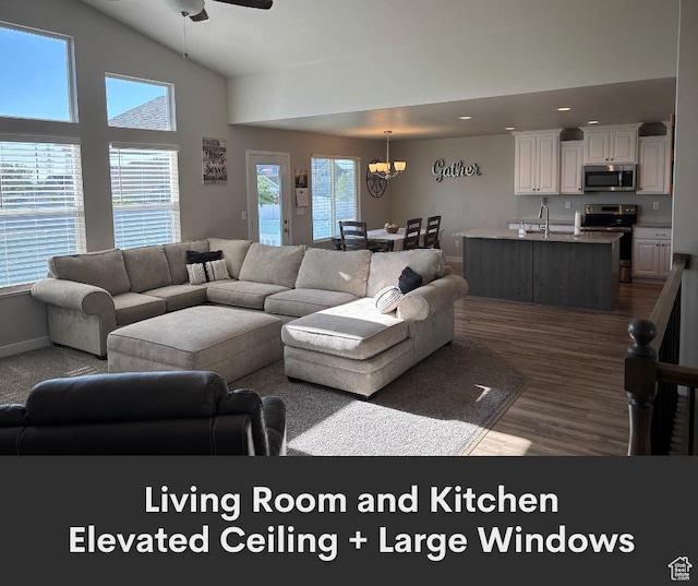 2447 N 2950 W, Plain City, UT 84404 - living room featuring a chandelier, ceiling fan, recessed lighting, dark wood-style flooring, and baseboards