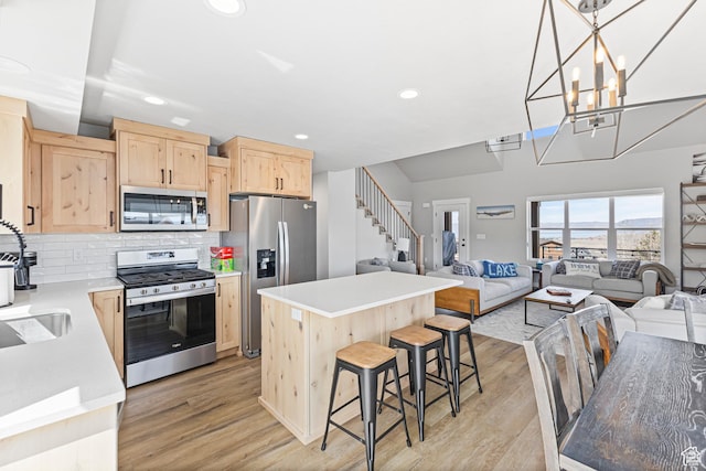 3467 S Porcupine Cir, Garden City, UT 84028 - kitchen with light wood-style floors, recessed lighting, appliances with stainless steel finishes, and light brown cabinets