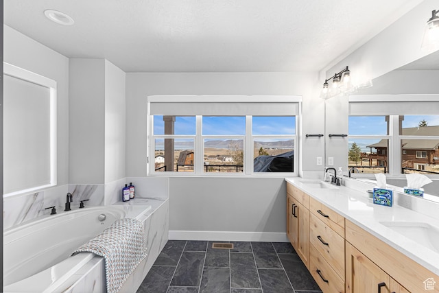 3467 S Porcupine Cir, Garden City, UT 84028 - full bath with double vanity, baseboards, a sink, and a healthy amount of sunlight