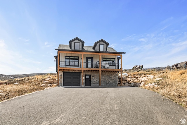 3467 S Porcupine Cir, Garden City, UT 84028 - raised beach house featuring a garage, a balcony, stone siding, board and batten siding, and driveway
