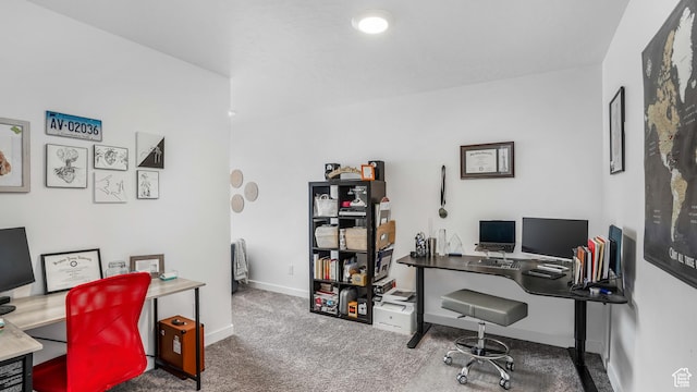 carpeted home office featuring baseboards