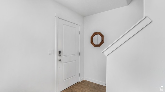 foyer with baseboards and wood finished floors