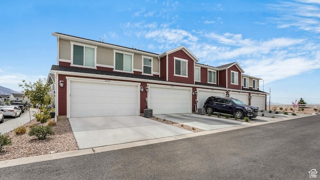 view of property with a garage and driveway