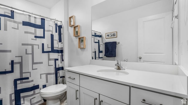 bathroom with vanity, a shower with shower curtain, and toilet