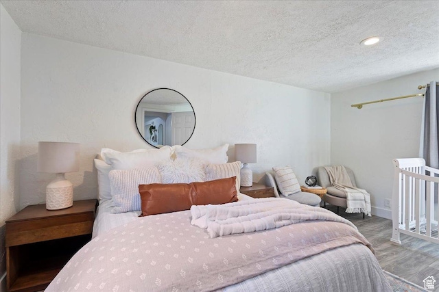 555 15th St, Ogden, UT 84404 - bedroom with recessed lighting, baseboards, a textured ceiling, and wood finished floors