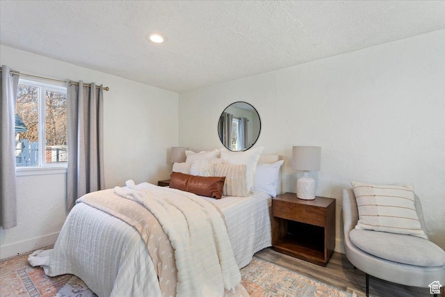 555 15th St, Ogden, UT 84404 - bedroom featuring recessed lighting, a textured ceiling, baseboards, and light wood finished floors