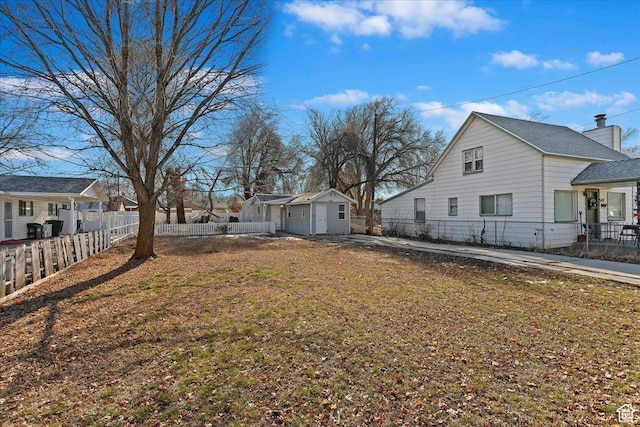 555 15th St, Ogden, UT 84404 - view of side of home with fence private yard and an outdoor structure