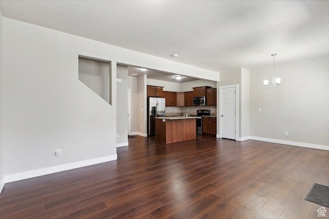 1545 N 420 W Unit 103, Logan, UT 84341 - unfurnished living room featuring a chandelier, dark wood finished floors, and baseboards