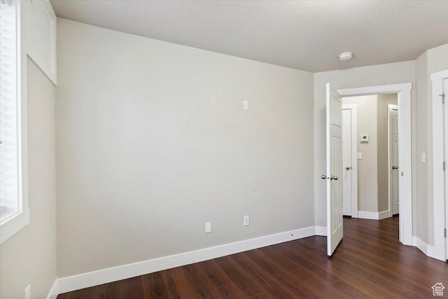1545 N 420 W Unit 103, Logan, UT 84341 - unfurnished bedroom featuring dark wood finished floors and baseboards