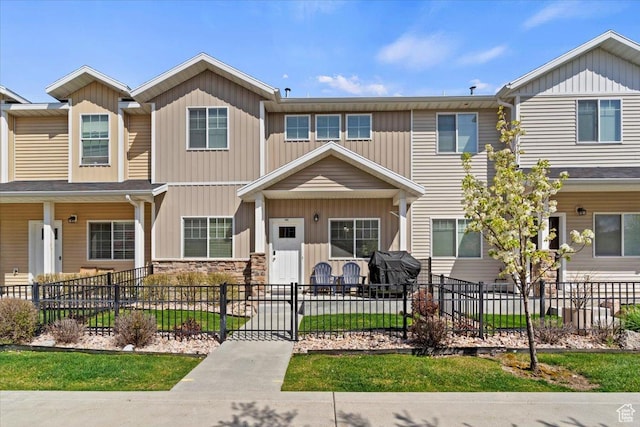 1545 N 420 W Unit 103, Logan, UT 84341 - view of property with board and batten siding and a fenced front yard