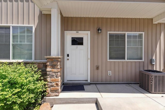 1545 N 420 W Unit 103, Logan, UT 84341 - doorway to property featuring central AC and board and batten siding
