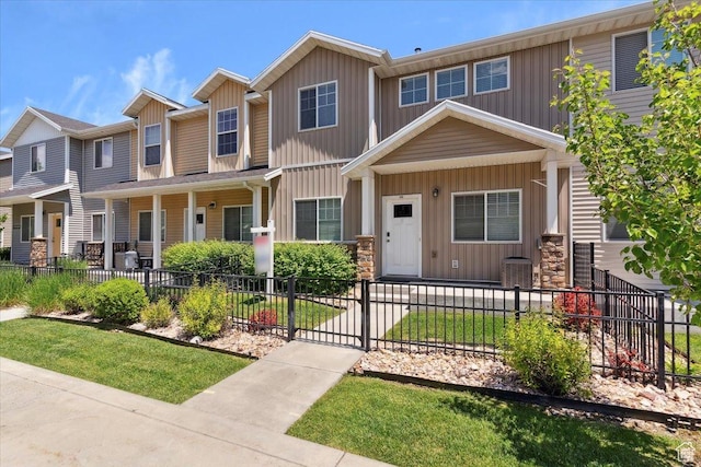 1545 N 420 W Unit 103, Logan, UT 84341 - view of property featuring board and batten siding, a fenced front yard, and covered porch