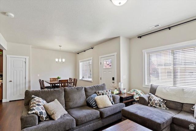 1545 N 420 W Unit 103, Logan, UT 84341 - living area with an inviting chandelier, dark wood finished floors, and visible vents
