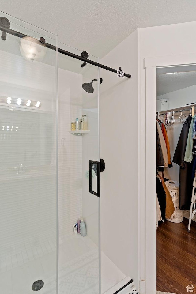 1545 N 420 W Unit 103, Logan, UT 84341 - full bath with a shower stall, a walk in closet, and wood finished floors