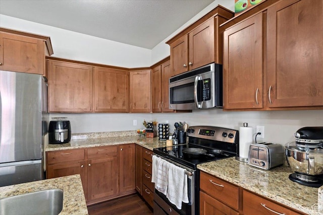 1545 N 420 W Unit 103, Logan, UT 84341 - kitchen with dark wood finished floors, appliances with stainless steel finishes, and brown cabinets