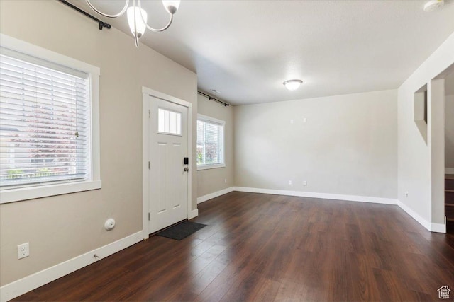 1545 N 420 W Unit 103, Logan, UT 84341 - foyer entrance featuring dark wood-type flooring, baseboards, and a chandelier