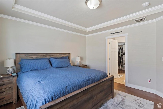 1545 N 420 W Unit 103, Logan, UT 84341 - bedroom featuring crown molding, visible vents, wood finished floors, and a raised ceiling