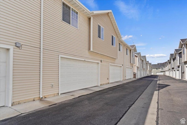 1545 N 420 W Unit 103, Logan, UT 84341 - view of side of home featuring a residential view and community garages