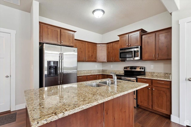 1545 N 420 W Unit 103, Logan, UT 84341 - kitchen featuring appliances with stainless steel finishes, a sink, dark wood-style floors, light stone counters, and a textured ceiling