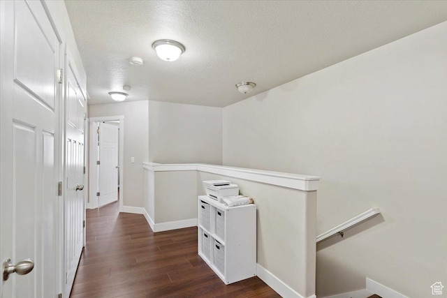 1545 N 420 W Unit 103, Logan, UT 84341 - hallway with baseboards, dark wood-style flooring, a textured ceiling, and an upstairs landing
