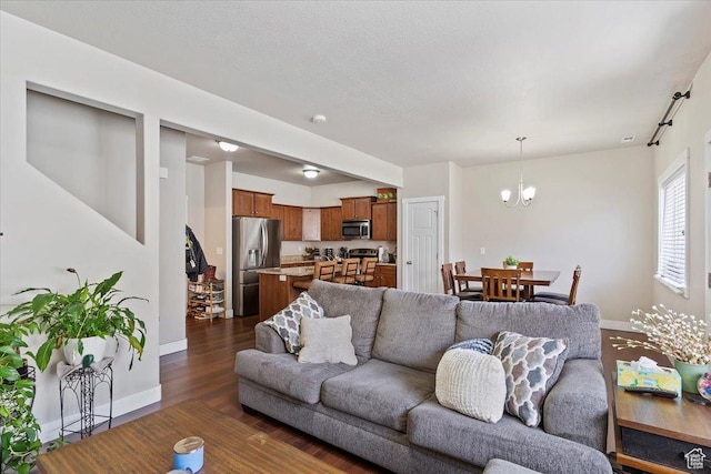 1545 N 420 W Unit 103, Logan, UT 84341 - living area featuring baseboards, a chandelier, and dark wood-style floors