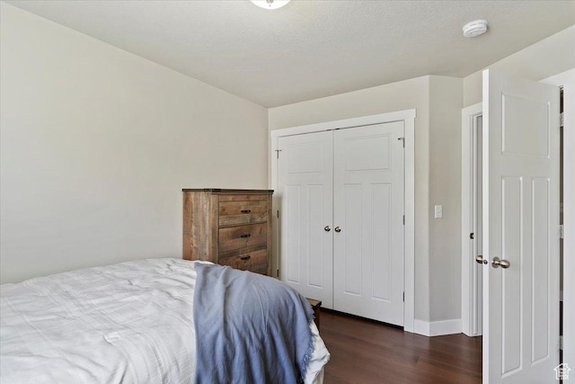 1545 N 420 W Unit 103, Logan, UT 84341 - bedroom featuring baseboards, dark wood-style floors, and a closet