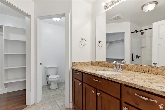 1545 N 420 W Unit 103, Logan, UT 84341 - full bath with a spacious closet, vanity, toilet, a shower, and baseboards