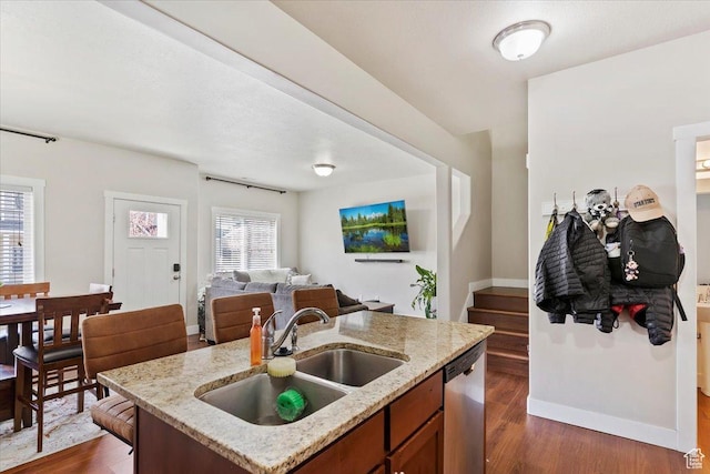 1545 N 420 W Unit 103, Logan, UT 84341 - kitchen featuring stainless steel dishwasher, baseboards, open floor plan, dark wood-type flooring, and a sink