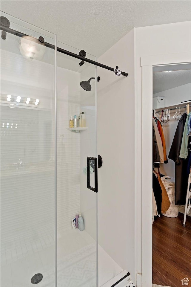 1545 N 420 W Unit 103, Logan, UT 84341 - bathroom featuring wood finished floors, a stall shower, and a spacious closet