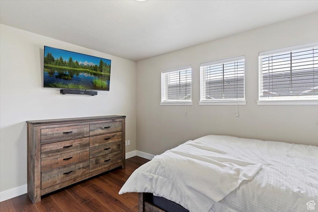 1545 N 420 W Unit 103, Logan, UT 84341 - bedroom with baseboards and dark wood-type flooring