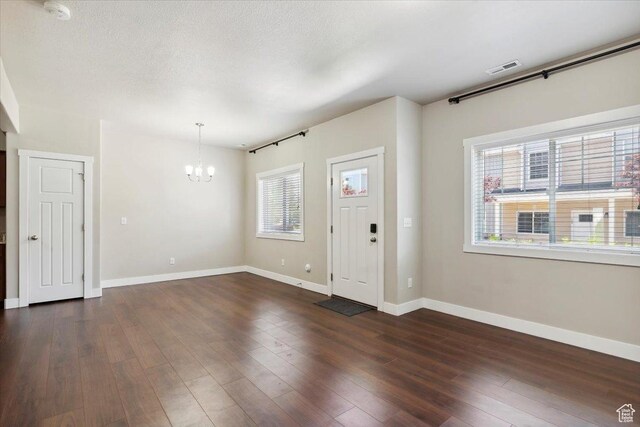 1545 N 420 W Unit 103, Logan, UT 84341 - foyer with a chandelier, baseboards, and dark wood-style floors