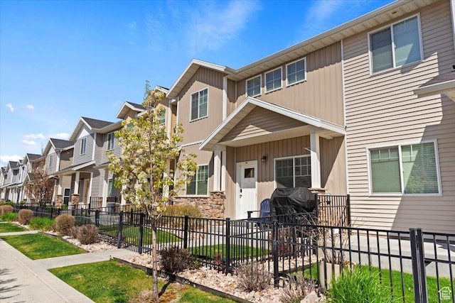 1545 N 420 W Unit 103, Logan, UT 84341 - view of property featuring board and batten siding, fence, and a residential view