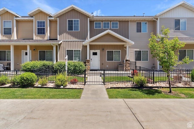 1545 N 420 W Unit 103, Logan, UT 84341 - townhome / multi-family property with board and batten siding and a fenced front yard
