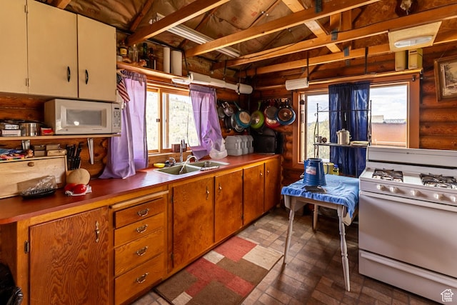 2185 Crestridge Rd Unit 51, Salina, UT 84654 - kitchen featuring a sink, brick patterned floor, a wealth of natural light, and white appliances