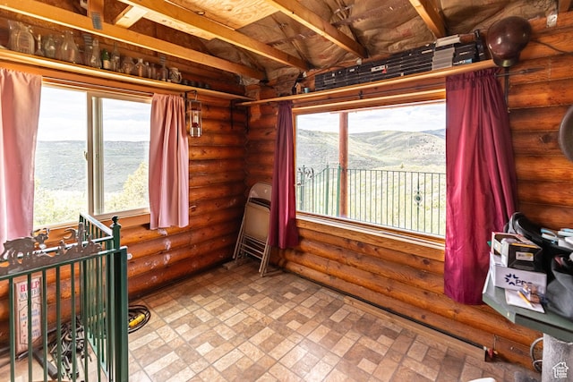 2185 Crestridge Rd Unit 51, Salina, UT 84654 - unfurnished room with a healthy amount of sunlight, log walls, brick patterned floor, and a mountain view