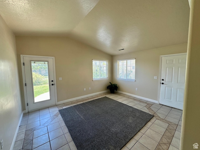 819 E 725 N, Ogden, UT 84404 - entrance foyer featuring a healthy amount of sunlight, light tile patterned floors, a textured ceiling, and lofted ceiling