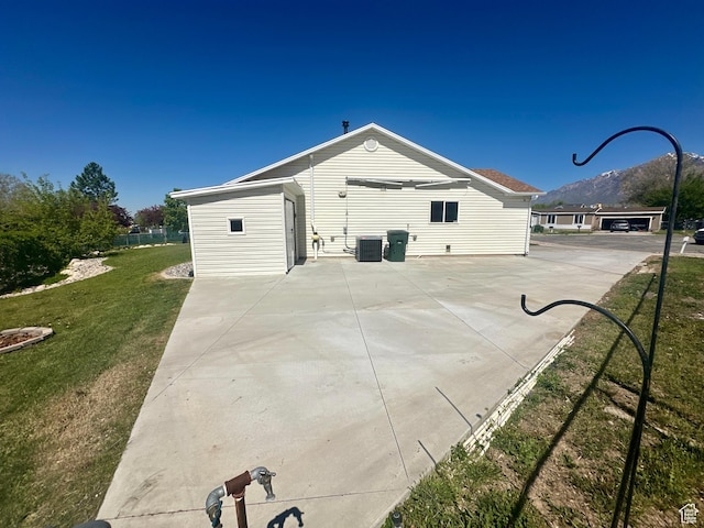 819 E 725 N, Ogden, UT 84404 - view of property exterior with a lawn, central AC unit, and a patio area