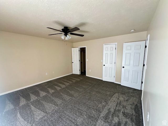 819 E 725 N, Ogden, UT 84404 - unfurnished bedroom featuring baseboards, ceiling fan, and dark carpet