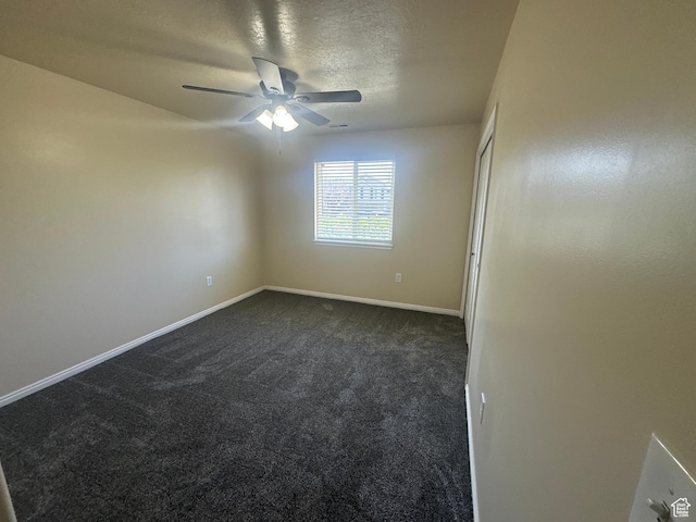 819 E 725 N, Ogden, UT 84404 - empty room featuring dark carpet, a ceiling fan, baseboards, and a textured ceiling