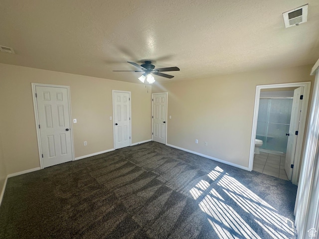 819 E 725 N, Ogden, UT 84404 - unfurnished bedroom with visible vents, baseboards, dark carpet, ensuite bathroom, and a textured ceiling