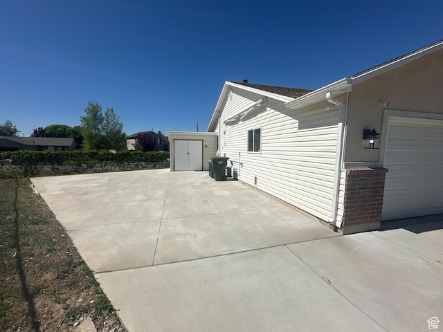 819 E 725 N, Ogden, UT 84404 - view of home's exterior featuring a patio area and a storage unit