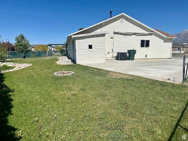 819 E 725 N, Ogden, UT 84404 - rear view of house with fence, cooling unit, an outdoor fire pit, a yard, and a patio