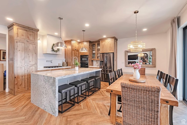 6433 N Glenmar Way, Eagle Mountain, UT 84005 - kitchen featuring an inviting chandelier, stainless steel fridge, a center island, multiple ovens, and glass insert cabinets