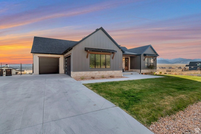 6433 N Glenmar Way, Eagle Mountain, UT 84005 - modern farmhouse style home with roof with shingles, a front lawn, a garage, a mountain view, and concrete driveway