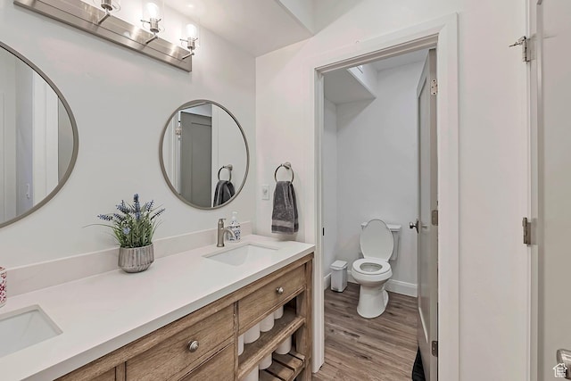 6433 N Glenmar Way, Eagle Mountain, UT 84005 - bathroom featuring double vanity, toilet, a sink, and wood finished floors
