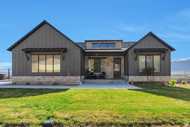 6433 N Glenmar Way, Eagle Mountain, UT 84005 - rear view of property with board and batten siding, a yard, and stone siding