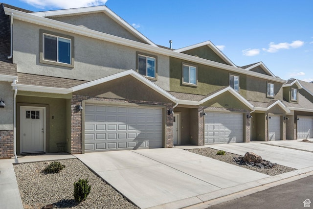 3154 W 1650 N Unit D, Cedar City, UT 84721 - townhome / multi-family property with an attached garage, stucco siding, driveway, and brick siding