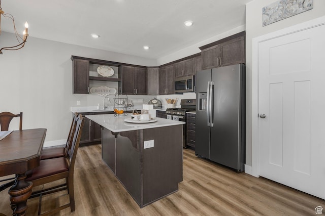 3154 W 1650 N Unit D, Cedar City, UT 84721 - kitchen with open shelves, dark brown cabinets, light countertops, light wood finished floors, and stainless steel appliances