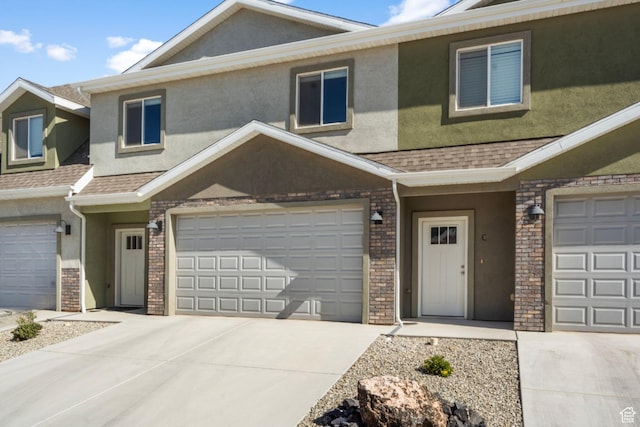 3154 W 1650 N Unit D, Cedar City, UT 84721 - multi unit property with concrete driveway, an attached garage, a shingled roof, and stucco siding